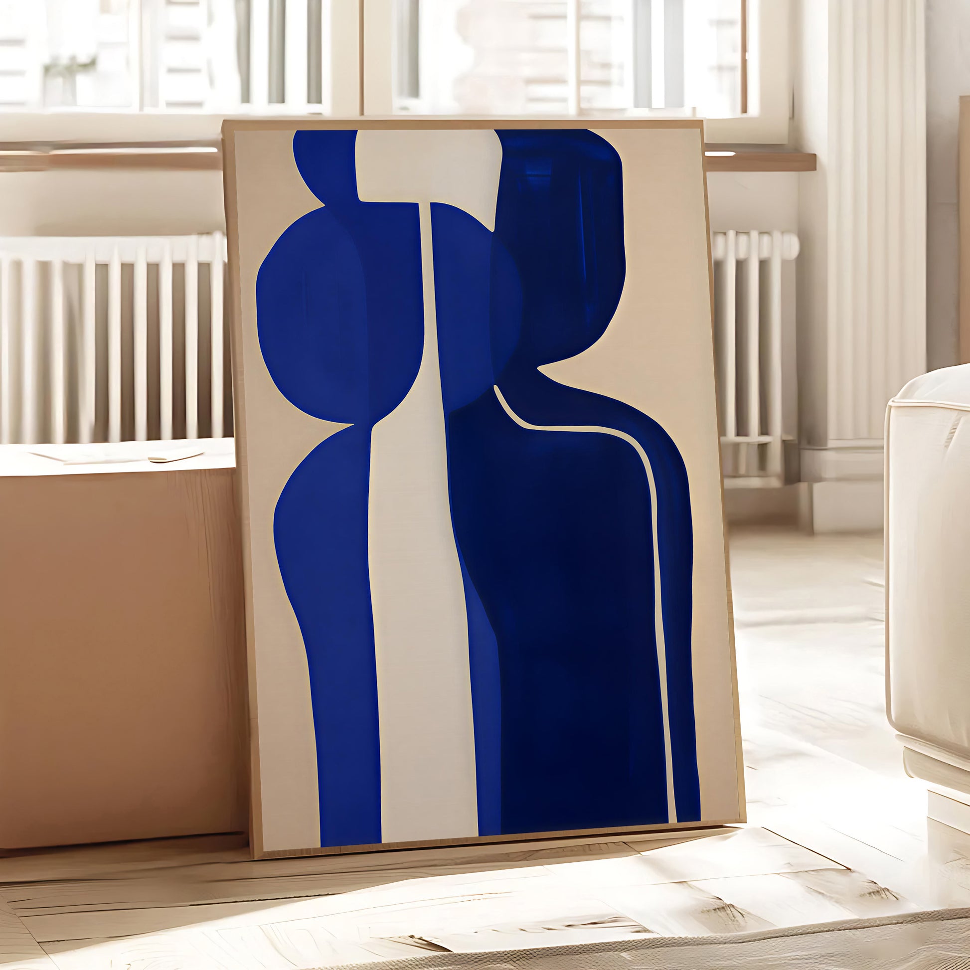 Abstract art piece with blue and beige shapes in a room with a radiator and window.