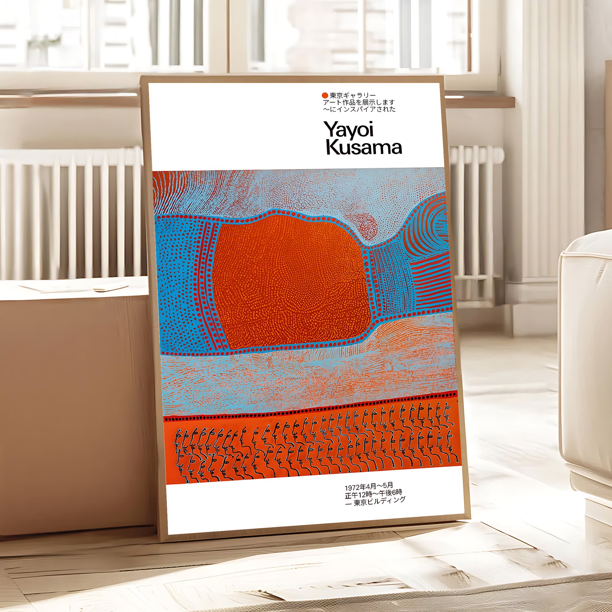 Framed artwork by Yayoi Kusama on a white wall in a room with a radiator and window.