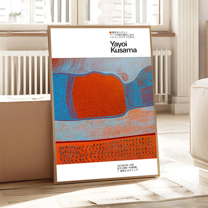 Framed artwork by Yayoi Kusama on a white wall in a room with a radiator and window.