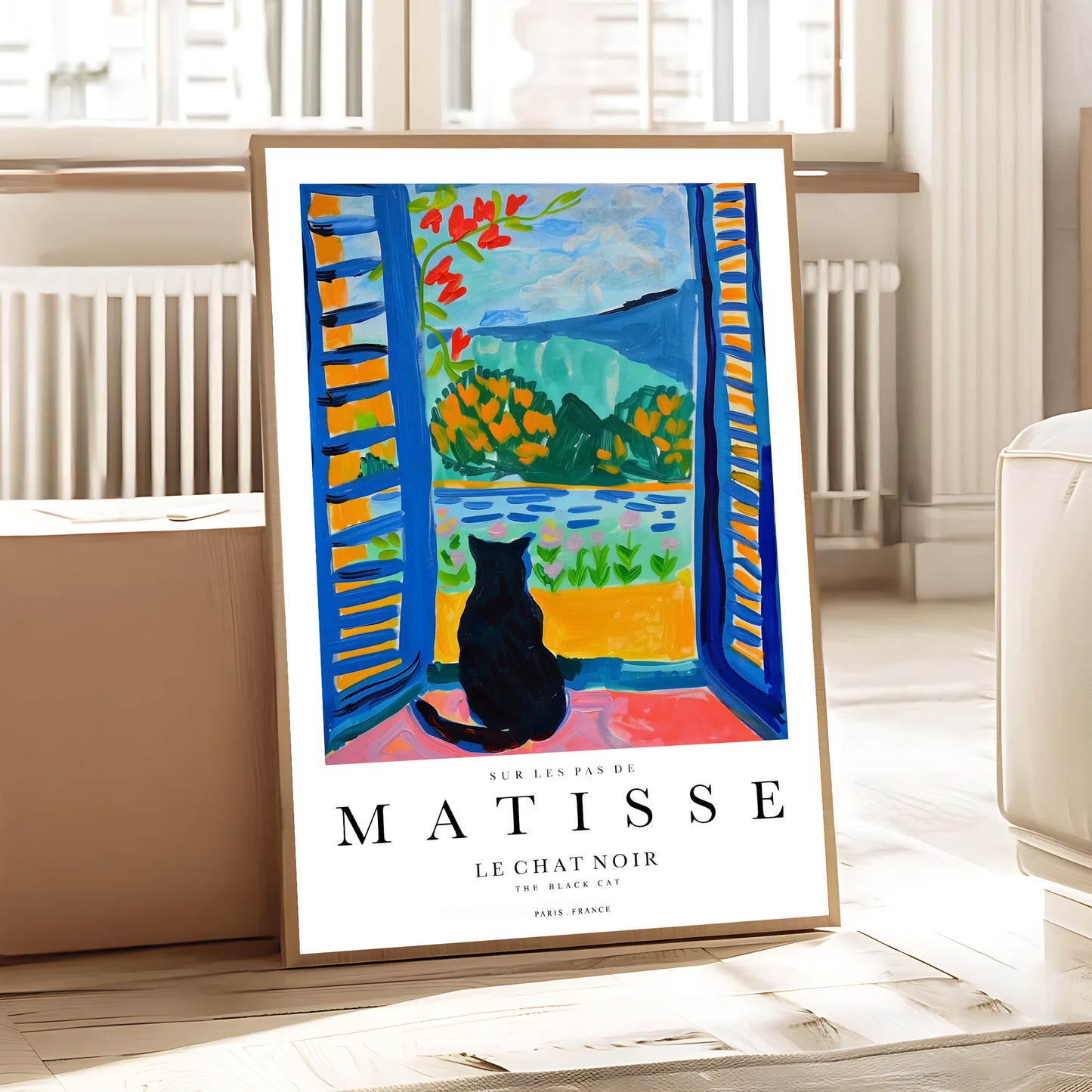 Framed Matisse art print of a black cat by a window in a room.