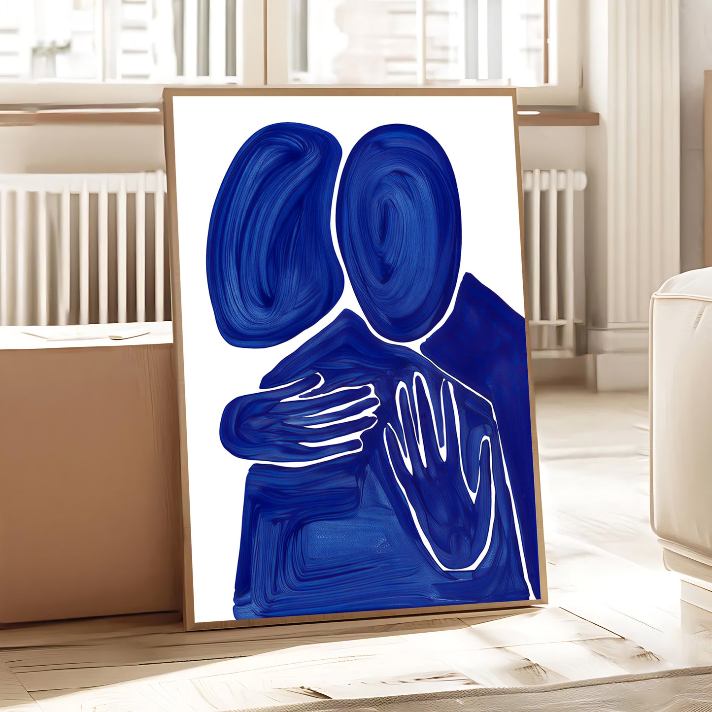 Abstract art piece with blue and white shapes on a white background, framed in a room.