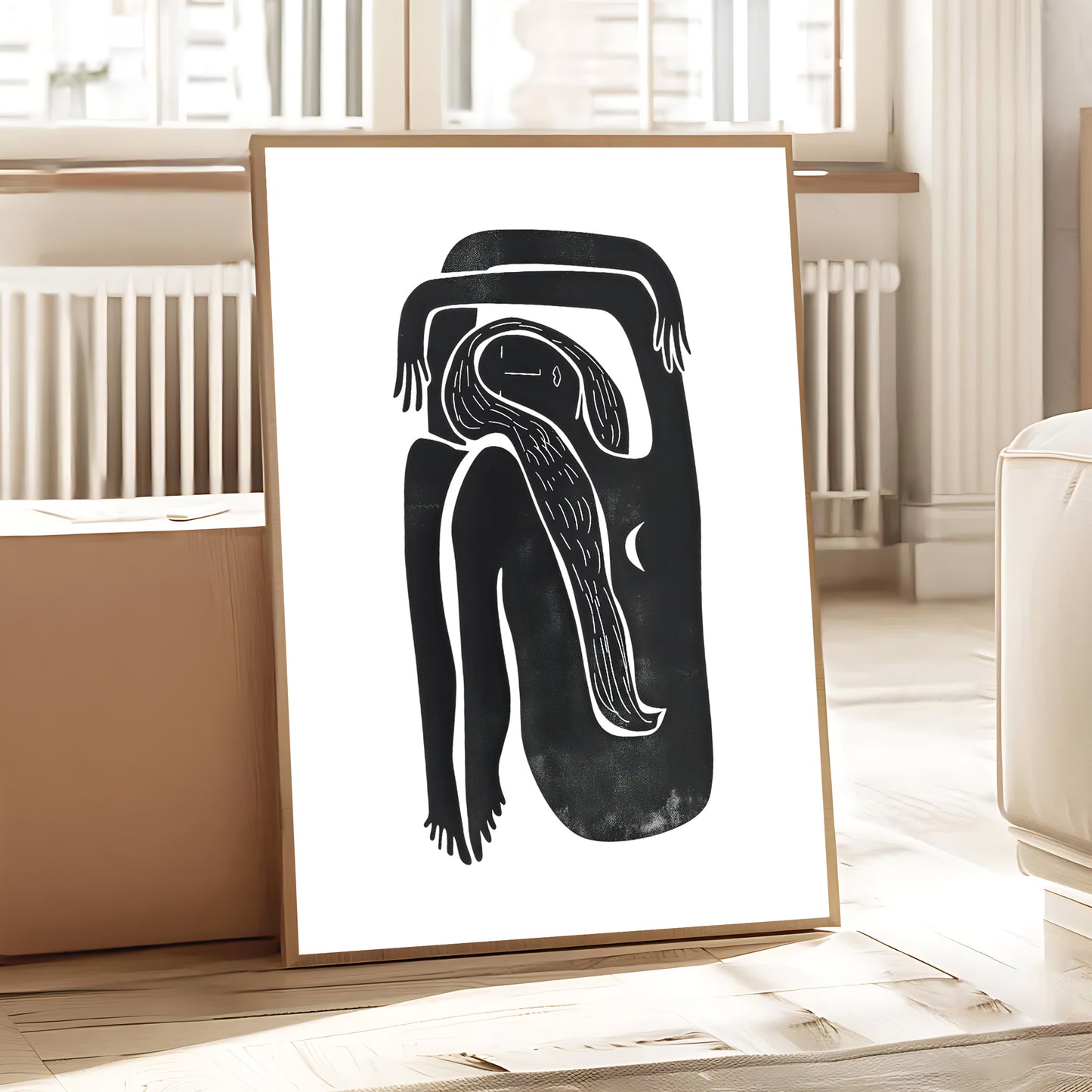 Framed abstract artwork of a black and white figure on a white wall.