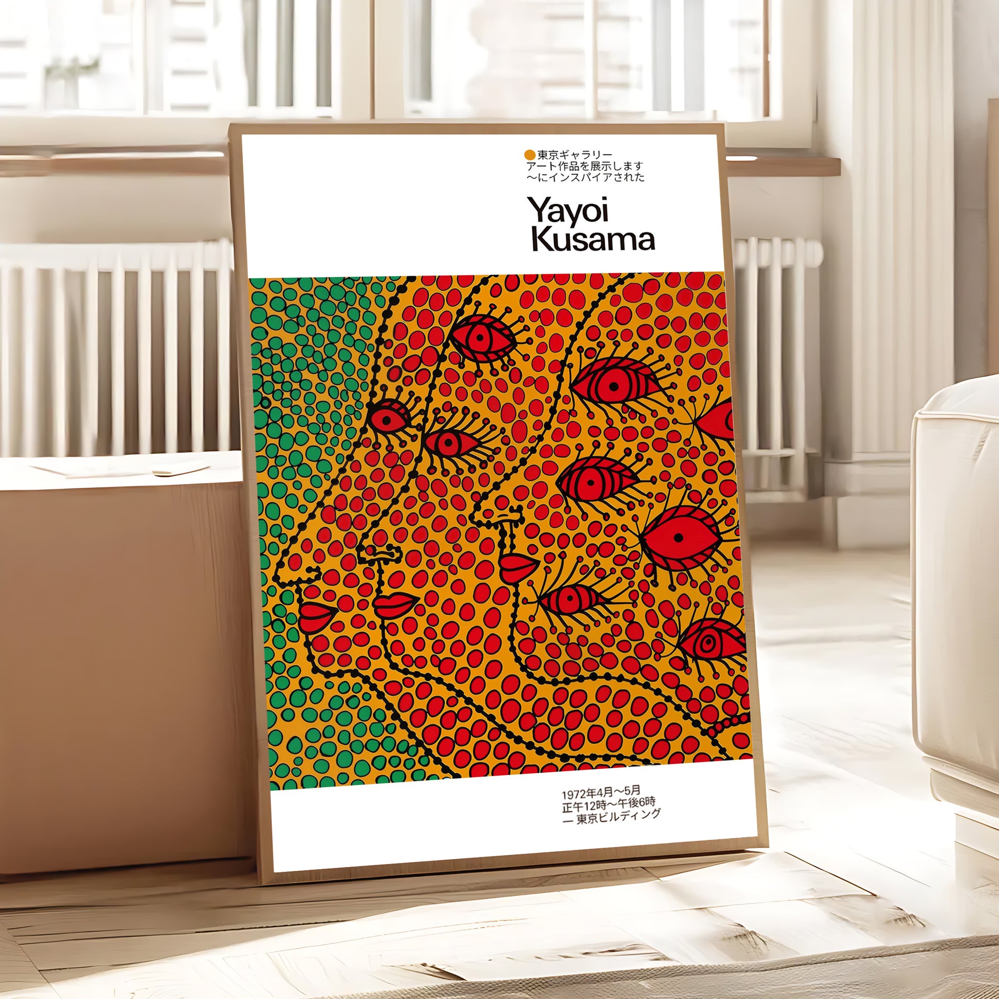 Vibrant polka dot abstract faces artwork with red eyes shown framed in a bright contemporary interior space