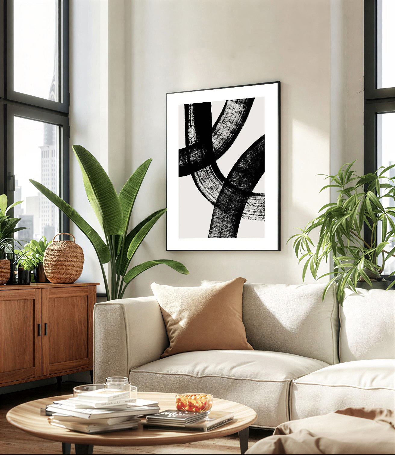 Modern living room with a beige sofa, round wooden coffee table, and abstract art on the wall.