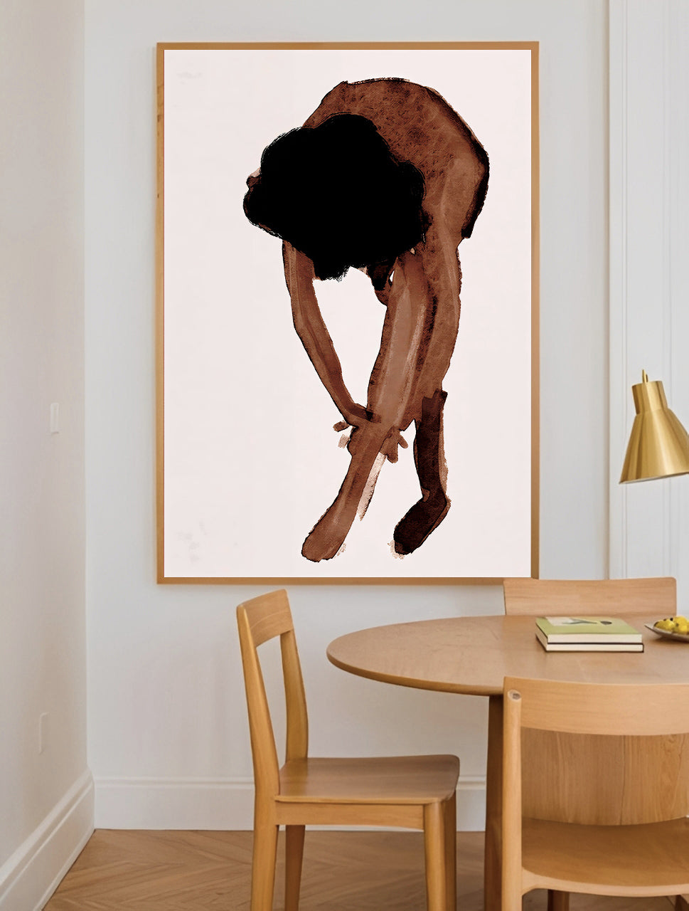 Dining room with a large framed artwork of a person on a white wall.