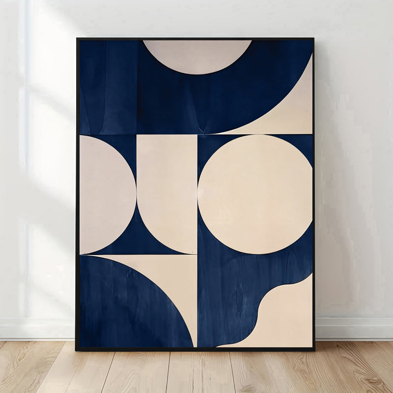 Abstract art print with geometric shapes in navy and beige on a white wall.