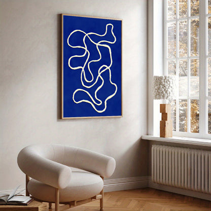 Abstract blue and white artwork on a wall in a room with a chair and window.