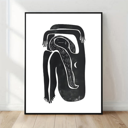 Framed black and white abstract artwork on a white wall.