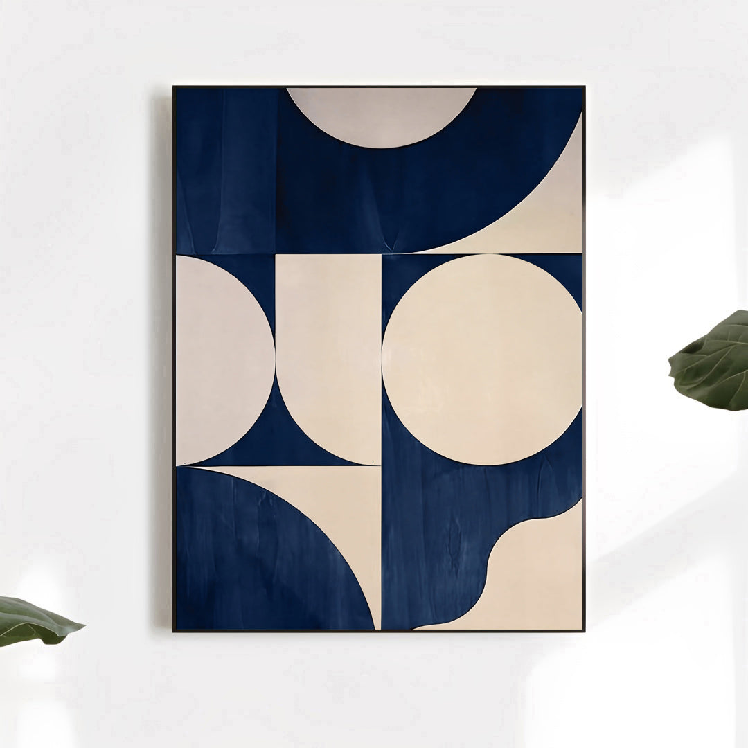 Geometric abstract art print with blue and beige circles on a white wall.