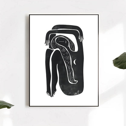 Framed black and white abstract artwork on a white wall with green leaves.